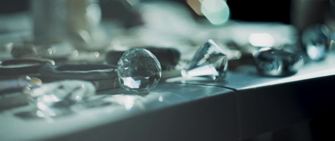 Sunlight is shining on clear cut crystal pieces sitting on a table