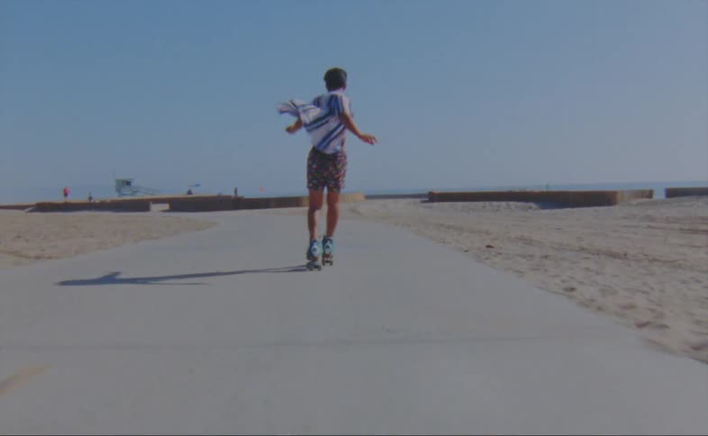 A man is skateboarding at the beach during the day time