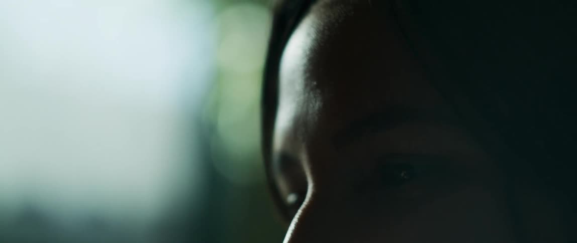 Woman smiles while watching intently