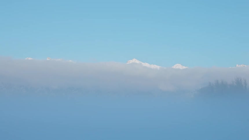 Distant view of high snowy mountains with clouds