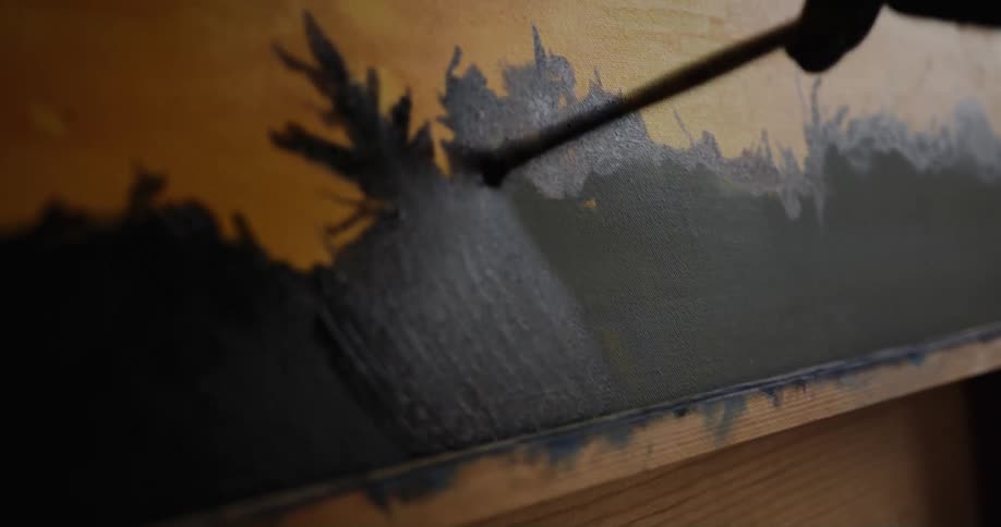 Artist applies paint to canvas