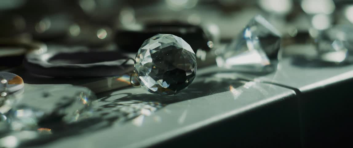 Light shines through glass crystals and orbs on a table display