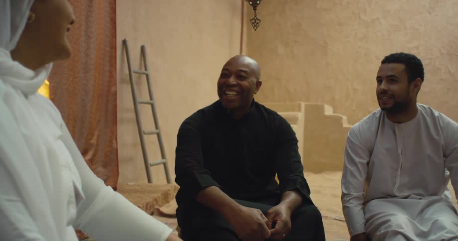 Three people talk together and laugh