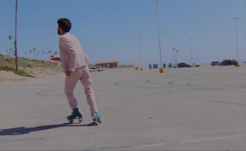 A man is dancing on roller skates in the lot