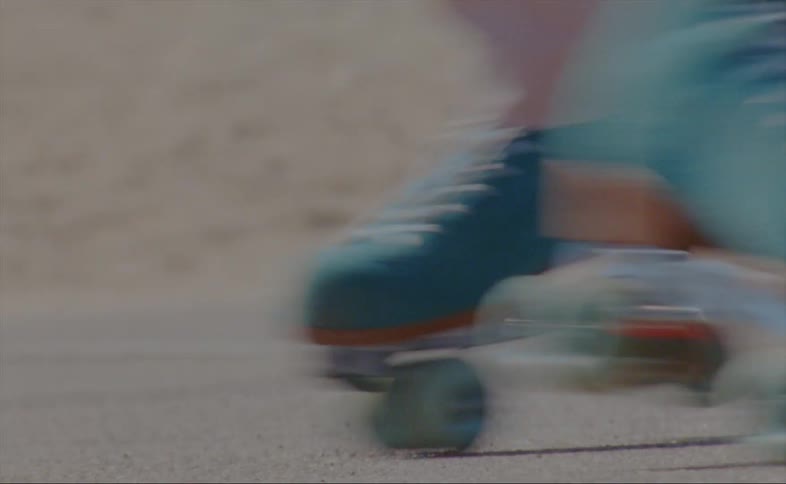 A person is skating outdoors on an empty road