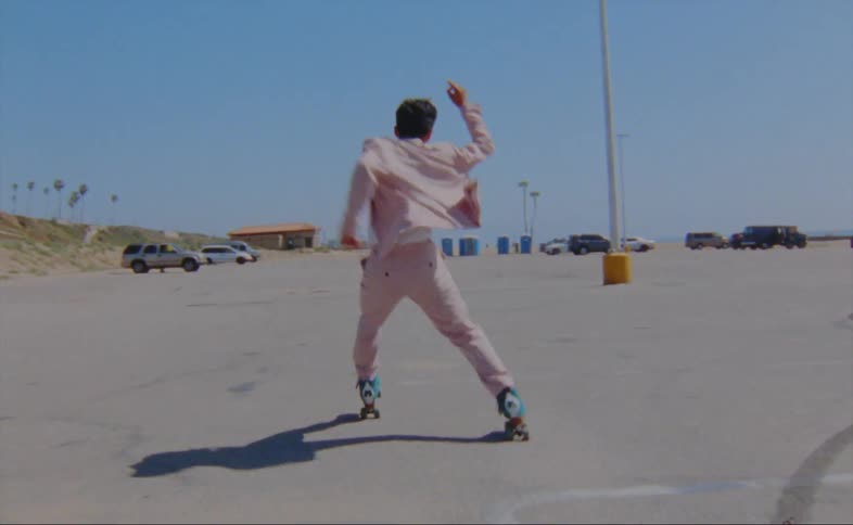 A man is skating outdoors during the spring time