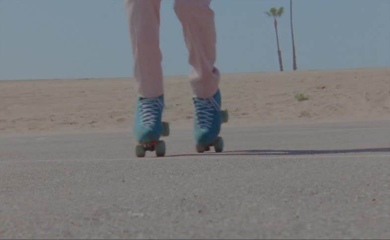 A person is skating on a street during the day time