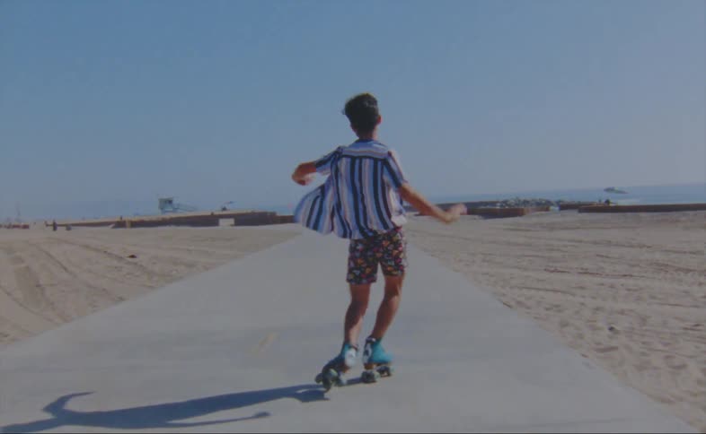 A man is skating outdoors at the beach
