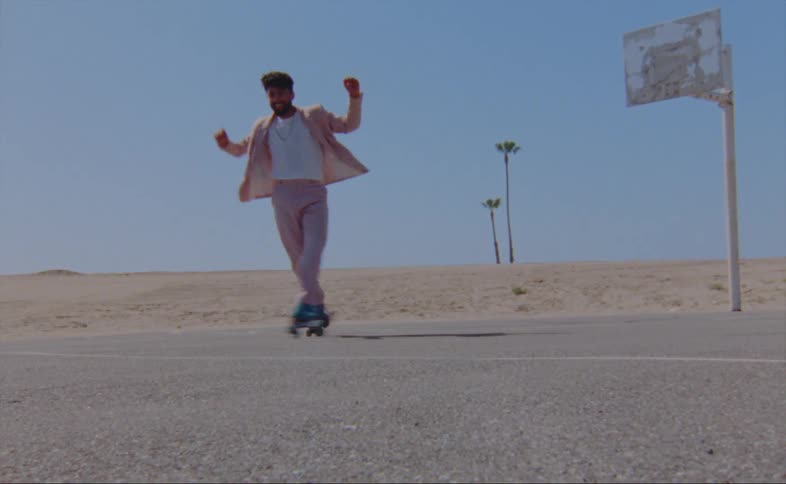 A man is skating on a road outdoors by himself