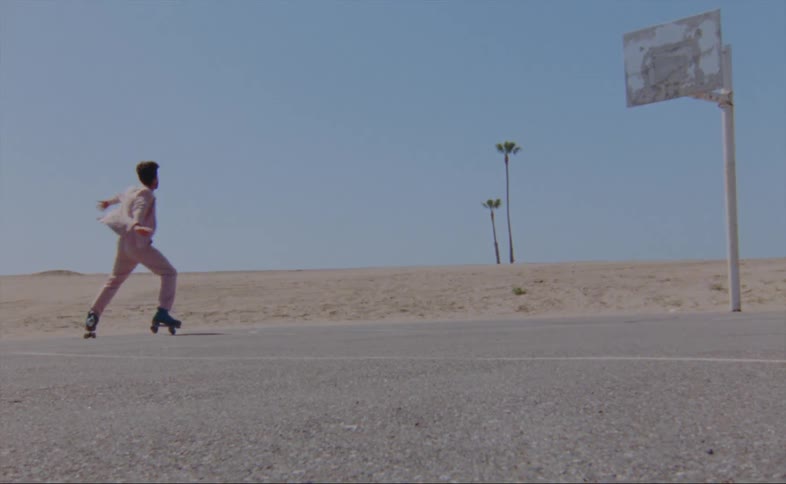 A man is skating around an empty street by himself