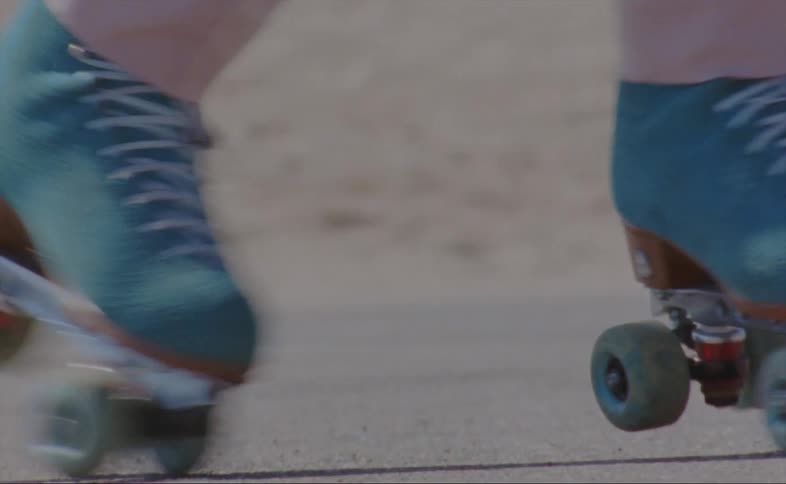 A person is skating near the sand
