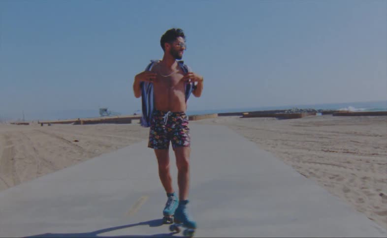A man is skating at the beach during the spring time