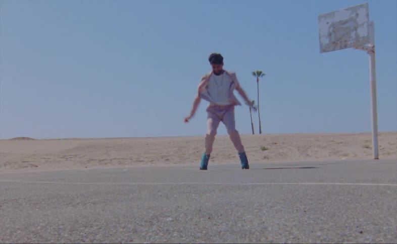 A man dances in roller skates near a basketball hoop