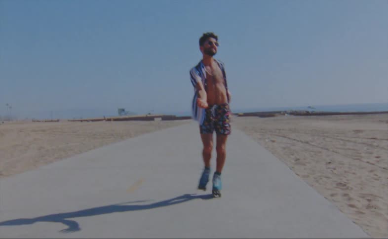 A man is roller skating on the boardwalk