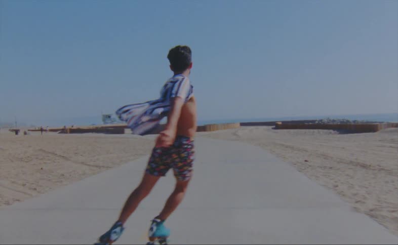A man is roller skating on the boardwalk