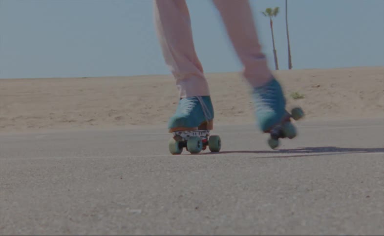 A man is skating on a street during the spring time