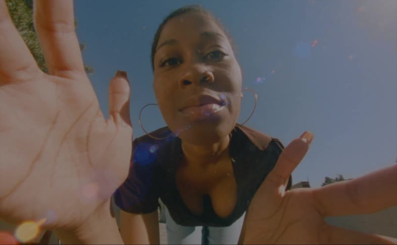 A woman is holding the camera and smiling