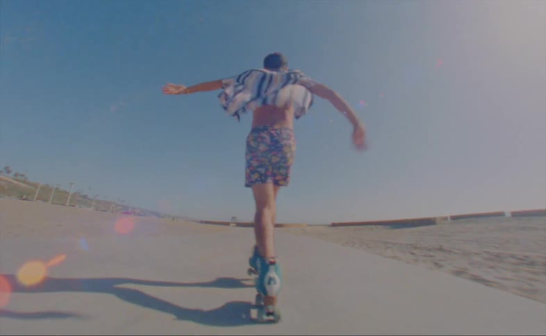 A man skating and dancing outdoors