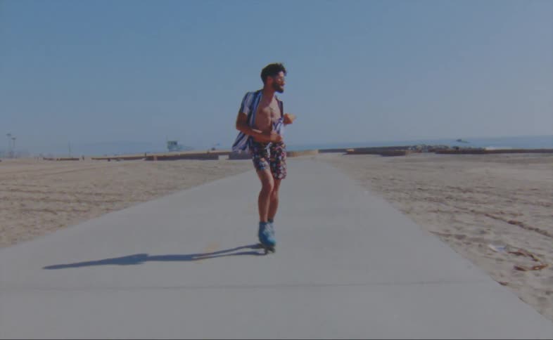 A man dancing on skates on a sidewalk