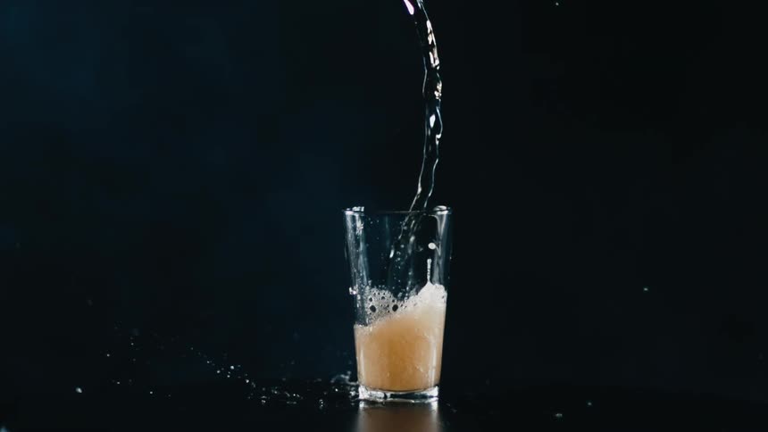 Beer is spilling into the glass