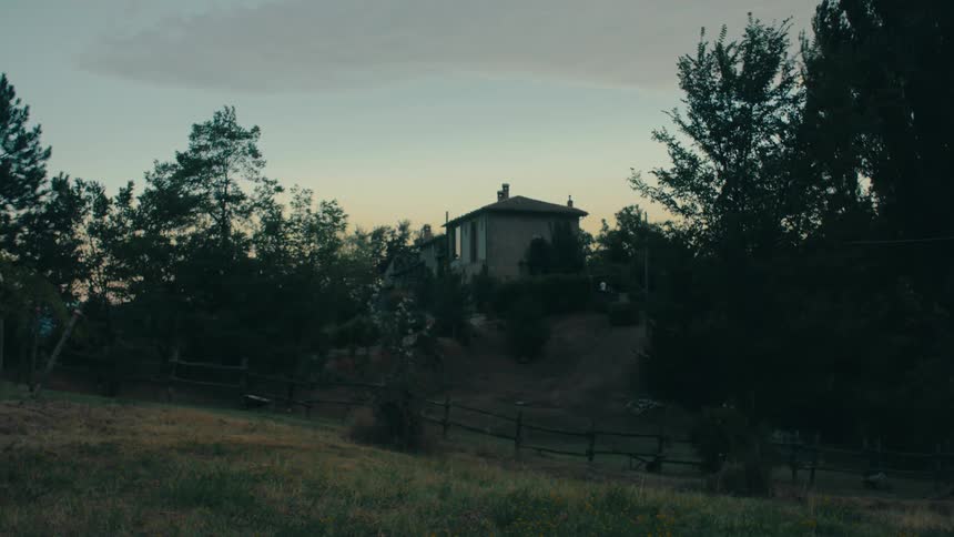 A house on a hill in the countryside in the evening