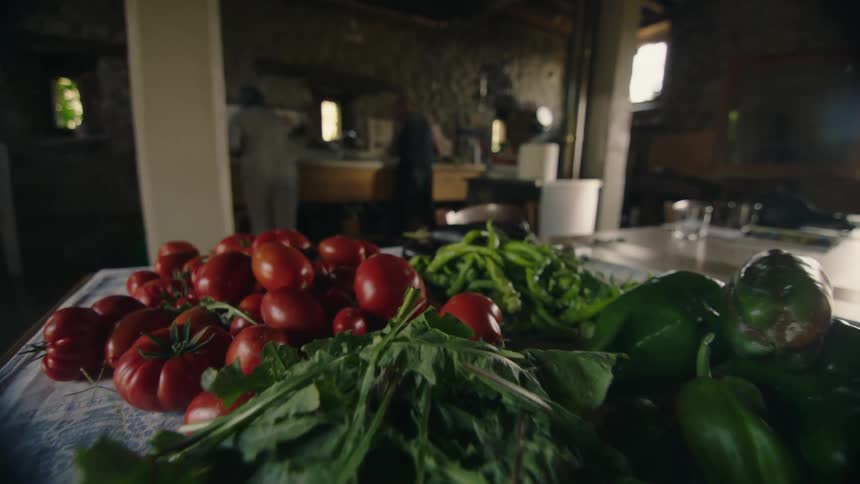 Fresh garden vegetables are on the counter in a kitchen