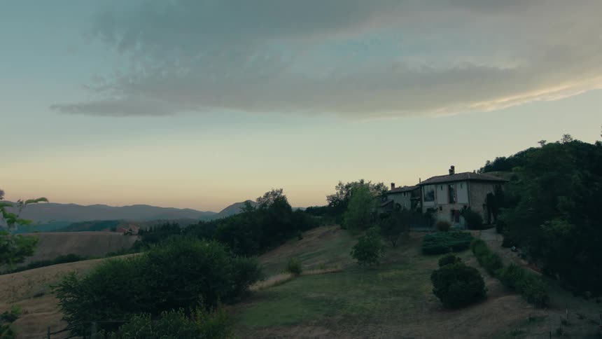 A house on a hill in the countryside in the evening