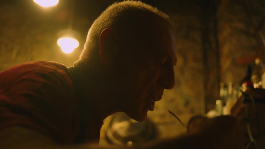 A man tastes food from a pot while cooking in a home kitchen