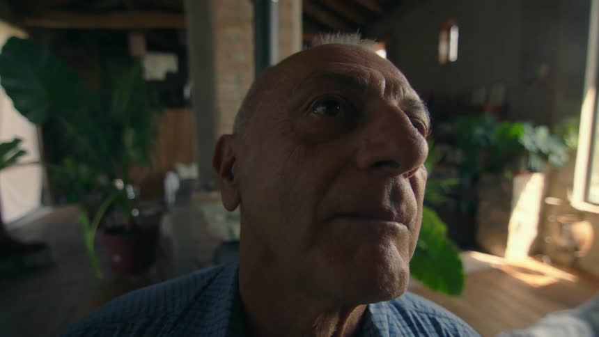 A man is talking in his house
