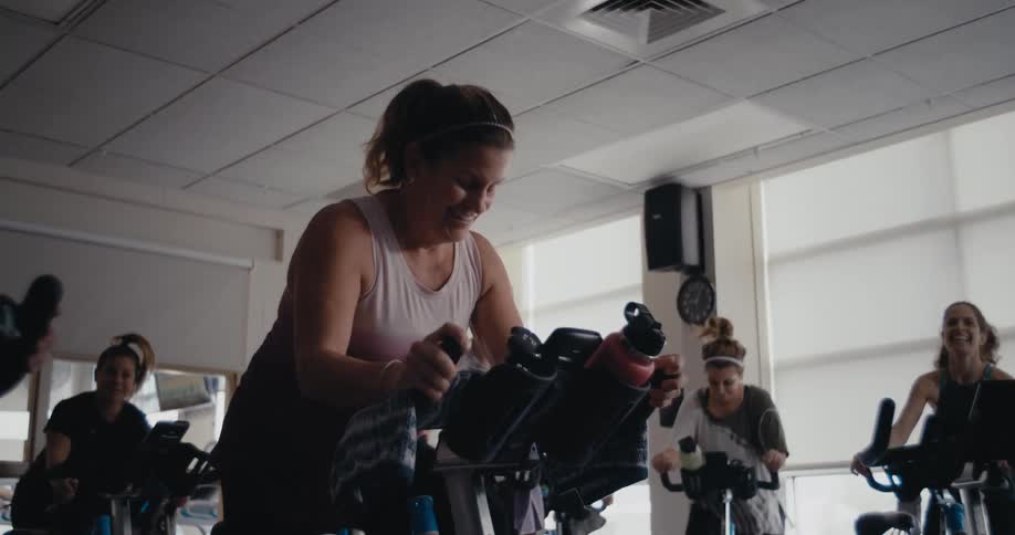 Women pedals exercise bikes in the gym