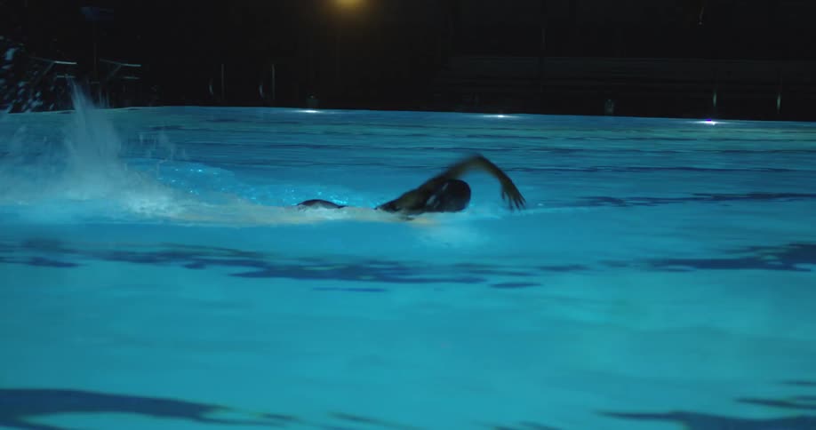 A woman dives into a swimming pool