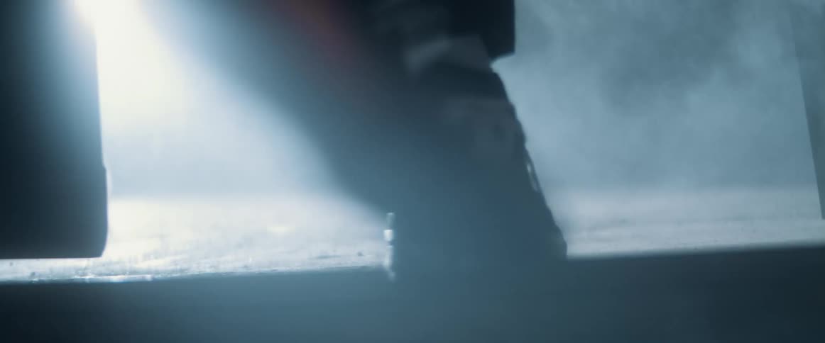 A person walks into a smoke filled room
