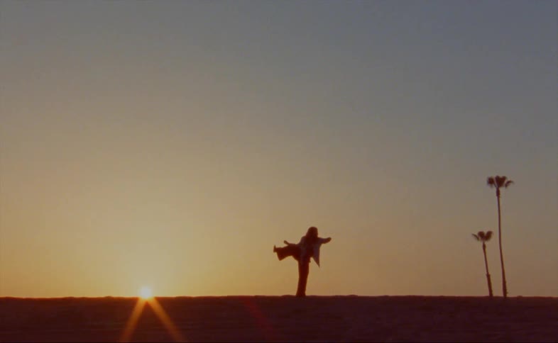 A woman is dancing at sunrise
