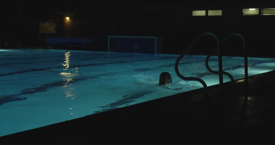 A person swims at night