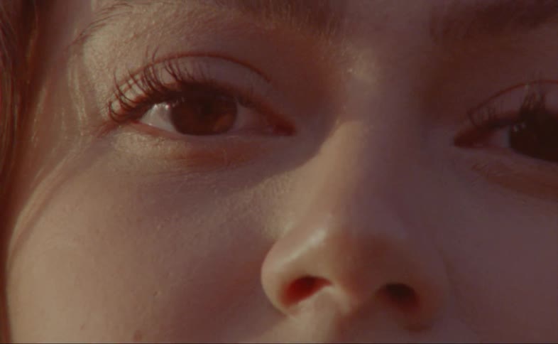 A womans face with the sunlight shining on it
