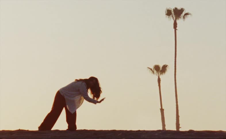 A woman is dancing at sunrise