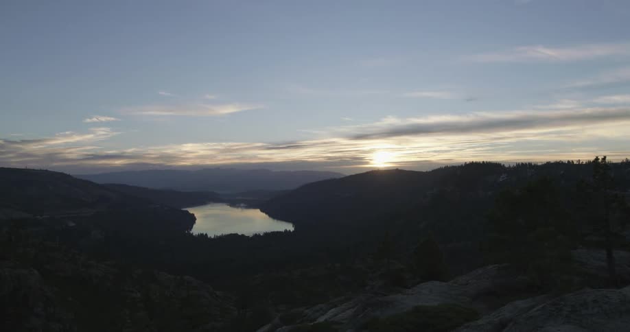 A skyline above a hilly area with a lake in the distance