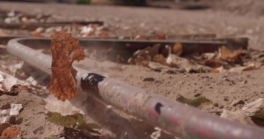 A metal pole drops into the dirt