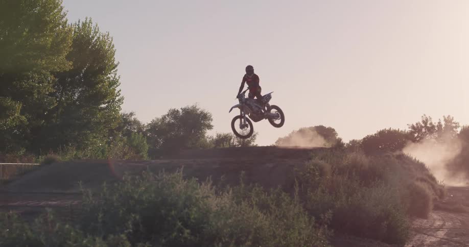 A person rides a motorcycle on a dirt track