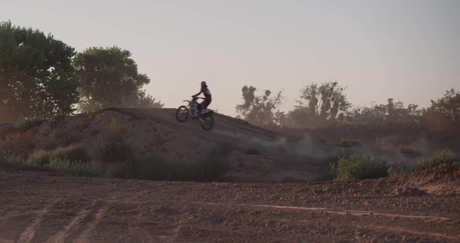 A person riding a bike on a dirt path