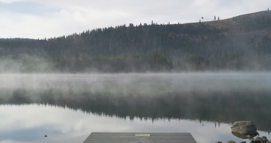 Steams floats over a mountain lake