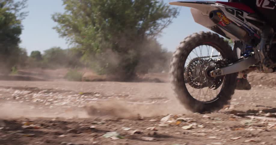 A dirt bike churns up dirt