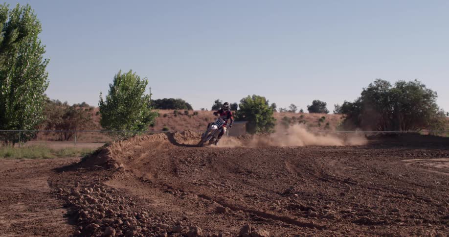 A person rides a dirt bike on a track