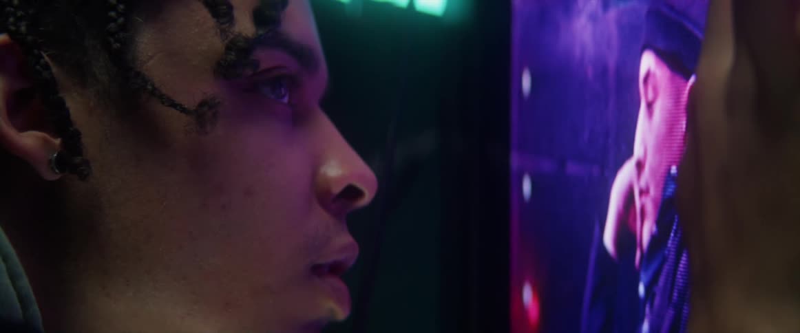 A man leans in to look at the television