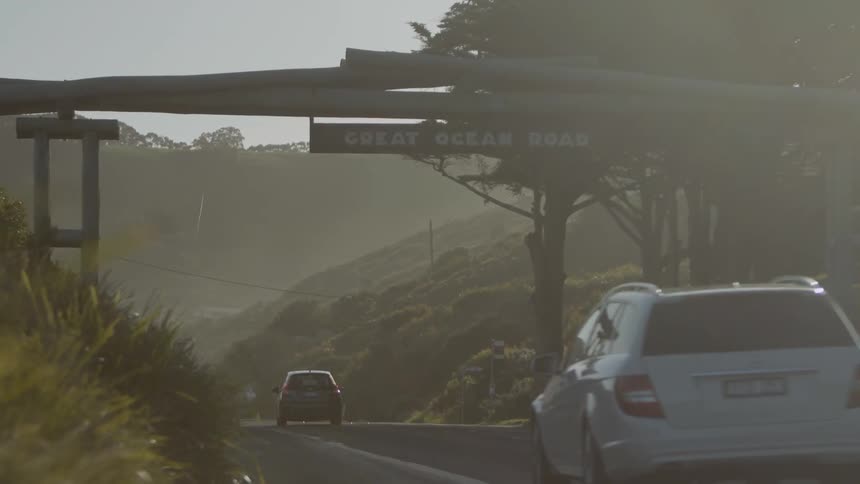 A car drives under a sign