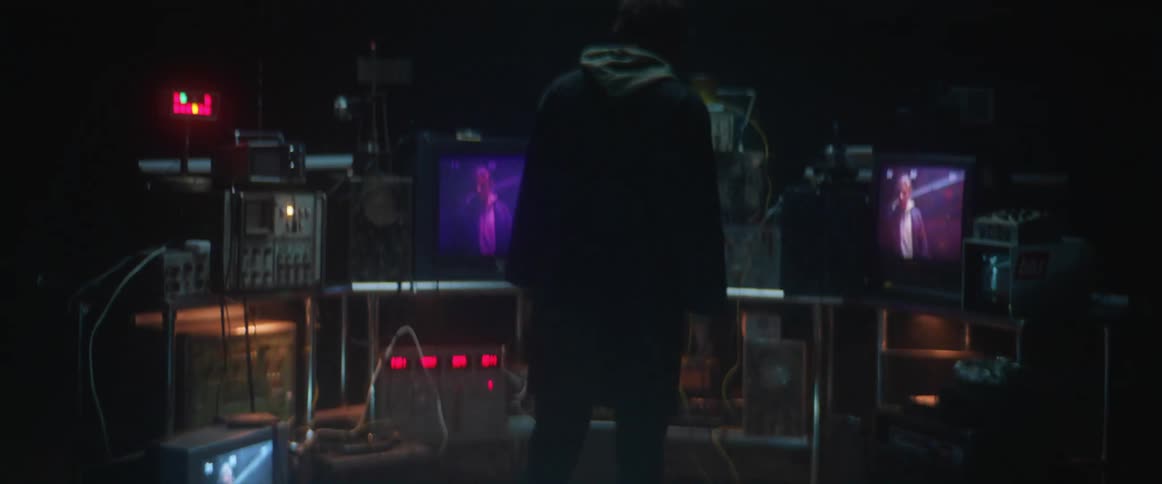 A man walking into a room with vintage technology