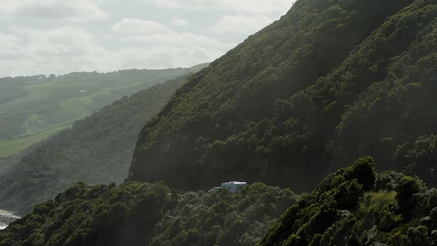 Caravan drives along coastal road