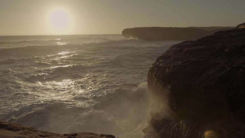 Waves crash on the rocks by the shore