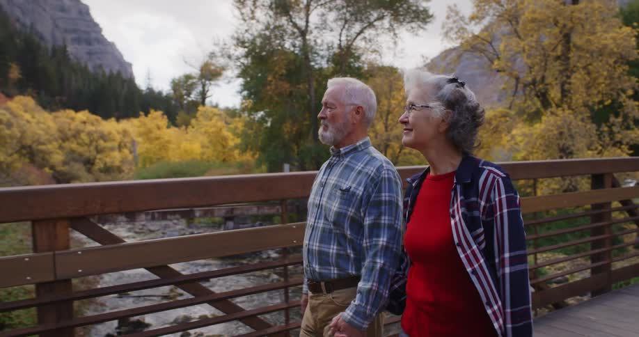 A man and woman cross the bridge