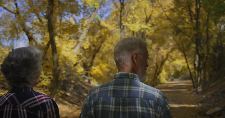 A man and woman hike in nature